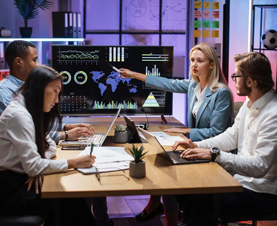 GettyImages-1353593268 Team analyzing data on large screen display.