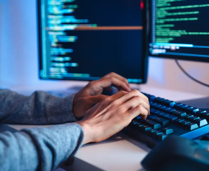 GettyImages-2160850981 Hands typing code on computer keyboard.